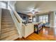 Inviting living room with staircase, fireplace, ceiling fan, hardwood floors, and neutral decor at 5050 Kinross Ln, Indian Land, SC 29707