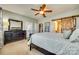 Bedroom with decorative mirror, barn door access to bathroom and access to back porch at 5050 Kinross Ln, Indian Land, SC 29707