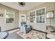 Cozy sunroom featuring neutral paint, tile floors, ample natural light, and comfortable seating for relaxing indoors at 5050 Kinross Ln, Indian Land, SC 29707