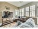 Bright sunroom featuring large windows, neutral paint, tile floors, and comfortable seating for relaxing and entertaining at 5050 Kinross Ln, Indian Land, SC 29707