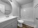 Clean bathroom with a tub/shower combination, gray vanity, and round mirror at 508 Danfield Dr, Clover, SC 29710