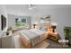 A neutral main bedroom boasts a large window, soft rug, side tables and king size bed at 508 Danfield Dr, Clover, SC 29710