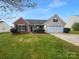 Charming single-Gathering home with a brick facade, shutters, landscaping and a two-car garage at 508 Danfield Dr, Clover, SC 29710