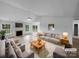 Bright living room with fireplace, ceiling fan, light gray sofa and chairs on an area rug at 508 Danfield Dr, Clover, SC 29710
