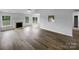 Bright living room with fireplace, wood flooring, large windows, ceiling fan, and open layout at 508 Danfield Dr, Clover, SC 29710