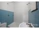 Bathroom features blue tiling on the walls and shower/tub combination at 627 N Flint St, Lincolnton, NC 28092