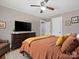 Cozy bedroom featuring a ceiling fan, a large dresser, and a comfortable bed with decorative pillows at 627 N Flint St, Lincolnton, NC 28092
