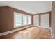 Light-filled bedroom with hardwood floors, neutral walls, and multiple windows for ample natural light at 627 N Flint St, Lincolnton, NC 28092
