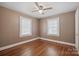 Bedroom showcasing hardwood floors, neutral paint, two windows, and a ceiling fan at 627 N Flint St, Lincolnton, NC 28092