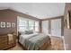 Well-lit bedroom with a wooden bed, large windows, neutral walls, and wood floors at 627 N Flint St, Lincolnton, NC 28092