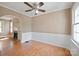 Bright dining area featuring hardwood floors, wainscoting, and a ceiling fan at 627 N Flint St, Lincolnton, NC 28092