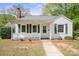 Charming single-story home featuring a welcoming front porch, classic white siding, and a well-maintained landscaped front yard at 627 N Flint St, Lincolnton, NC 28092