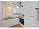 Bright kitchen featuring white cabinets, laminate countertops, and modern appliances at 627 N Flint St, Lincolnton, NC 28092