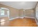Spacious living room showcasing hardwood floors and an open archway to another room at 627 N Flint St, Lincolnton, NC 28092
