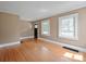 Bright living room with hardwood floors, natural light from two windows, and neutral paint at 627 N Flint St, Lincolnton, NC 28092