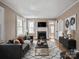 Spacious living room with hardwood floors, a decorative fireplace, and ample natural light at 627 N Flint St, Lincolnton, NC 28092
