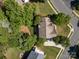 An aerial view of the home with a well-maintained lawn, mature trees, and a driveway leading to the garage at 6904 Mordred Ln, Charlotte, NC 28277