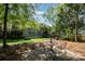 Charming backyard patio area with outdoor seating and natural surroundings at 6904 Mordred Ln, Charlotte, NC 28277