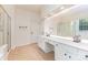 Bathroom featuring double sink vanity with white cabinets, plus gold framed shower at 6904 Mordred Ln, Charlotte, NC 28277