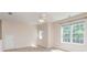 Spacious bedroom with neutral carpet, large window, and ample natural light at 6904 Mordred Ln, Charlotte, NC 28277