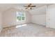 Bright bedroom with a large window and plush carpeting at 6904 Mordred Ln, Charlotte, NC 28277