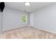 Bright bedroom featuring neutral walls, carpet, a window and closet door at 6904 Mordred Ln, Charlotte, NC 28277