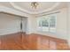 Open dining area featuring hardwood floors, stylish light fixtures, and a large window at 6904 Mordred Ln, Charlotte, NC 28277