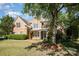 Beautiful brick home featuring well-kept lawn, front flower boxes, and mature trees at 6904 Mordred Ln, Charlotte, NC 28277