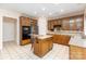 Well-lit kitchen with glass-front cabinets, stainless steel appliances, and an island at 6904 Mordred Ln, Charlotte, NC 28277