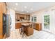 Bright eat-in kitchen featuring an island with seating and stainless steel appliances at 6904 Mordred Ln, Charlotte, NC 28277
