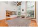 Spacious living room featuring a fireplace, tall windows, and a ceiling fan at 6904 Mordred Ln, Charlotte, NC 28277