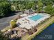 Community pool and playground are nestled in lush green space near a pond at 6904 Mordred Ln, Charlotte, NC 28277