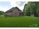 Expansive lush green backyard featuring home, fenced in yard, and brick storage shed at 6927 Ellington Farm Ln, Mint Hill, NC 28227