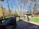 Expansive backyard with lush lawn and private deck, perfect for outdoor enjoyment and entertaining with picturesque wooded backdrop at 6927 Ellington Farm Ln, Mint Hill, NC 28227