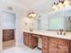 Bright bathroom featuring double sinks, tile floors, and a large mirror at 6927 Ellington Farm Ln, Mint Hill, NC 28227
