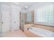 Bright bathroom with a separate shower and soaking tub at 6927 Ellington Farm Ln, Mint Hill, NC 28227
