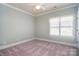 Bright bedroom with a ceiling fan and a large window, offering natural light and comfort at 6927 Ellington Farm Ln, Mint Hill, NC 28227