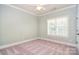 Cozy bedroom with a ceiling fan, soft carpeting, and a window, creating a comfortable retreat at 6927 Ellington Farm Ln, Mint Hill, NC 28227