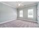 Serene bedroom featuring two windows for ample light and soft carpeting for a relaxing ambiance at 6927 Ellington Farm Ln, Mint Hill, NC 28227