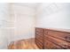 Walk in closet with custom shelving and a built-in dresser at 6927 Ellington Farm Ln, Mint Hill, NC 28227