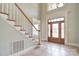 Welcoming foyer features tiled floor, staircase, and front door with decorative glass at 6927 Ellington Farm Ln, Mint Hill, NC 28227