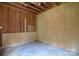 Unfinished space with plywood walls and concrete floors, ready to be customized at 6927 Ellington Farm Ln, Mint Hill, NC 28227