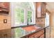 Kitchen featuring a copper sink, granite countertops, and a large window with backyard views at 6927 Ellington Farm Ln, Mint Hill, NC 28227