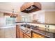 Gourmet kitchen featuring stainless steel appliances, a gas cooktop, and a custom range hood at 6927 Ellington Farm Ln, Mint Hill, NC 28227