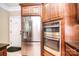 Kitchen featuring stainless steel appliances, wooden cabinets, and an adjacent doorway at 6927 Ellington Farm Ln, Mint Hill, NC 28227