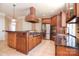 Modern kitchen with stainless appliances, granite countertops, custom cabinets, and tile flooring at 6927 Ellington Farm Ln, Mint Hill, NC 28227