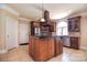 Elegant kitchen with stainless steel appliances, a large island, tile floors, and wooden cabinets at 6927 Ellington Farm Ln, Mint Hill, NC 28227
