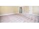 Spacious living room with neutral walls, carpeted floors, and a glass-paneled door for natural light at 6927 Ellington Farm Ln, Mint Hill, NC 28227