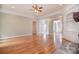 Spacious living room with hardwood floors, stone fireplace, and double doors that lead to the backyard at 6927 Ellington Farm Ln, Mint Hill, NC 28227