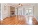 Large living room with hardwood floors, stone fireplace, built-in cabinets and access to patio at 6927 Ellington Farm Ln, Mint Hill, NC 28227